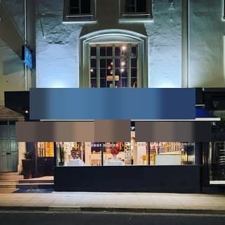 The Illuminated Copper Vine Storefront On Montpellier Walk At Night